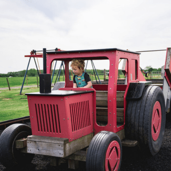 Child in a play tractor
