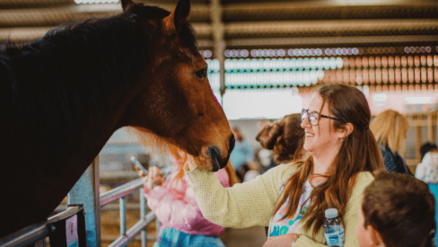 Mum stroking a horse