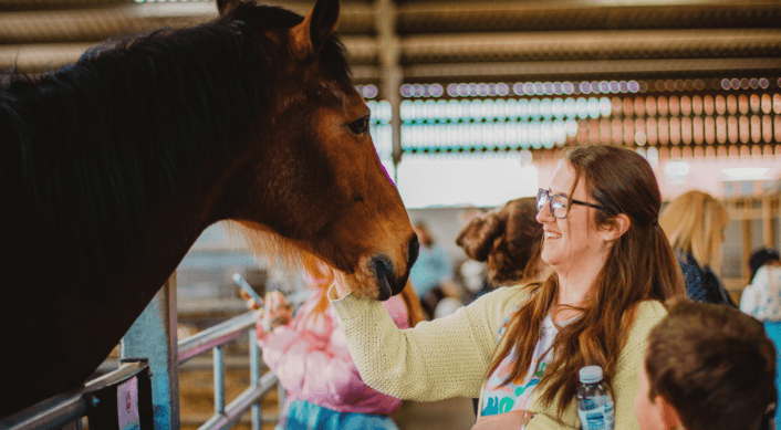 Mum stroking a horse