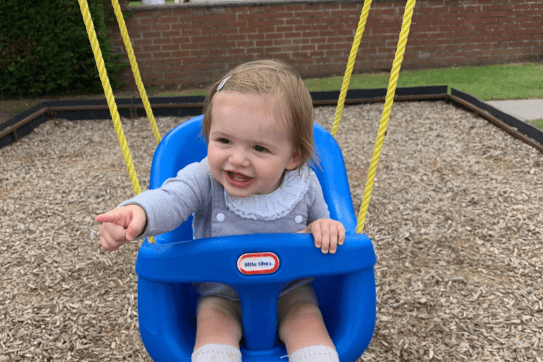 Young child on a baby swing
